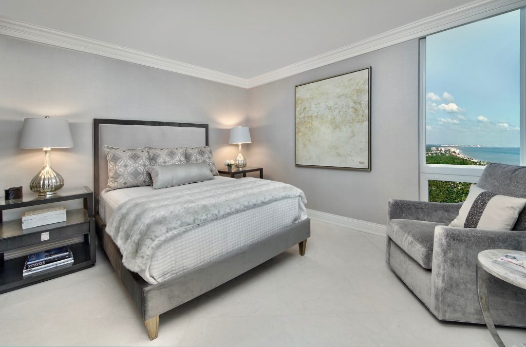 Lovely guest bedroom with shades of grays with white and black accents. Contemporary art.